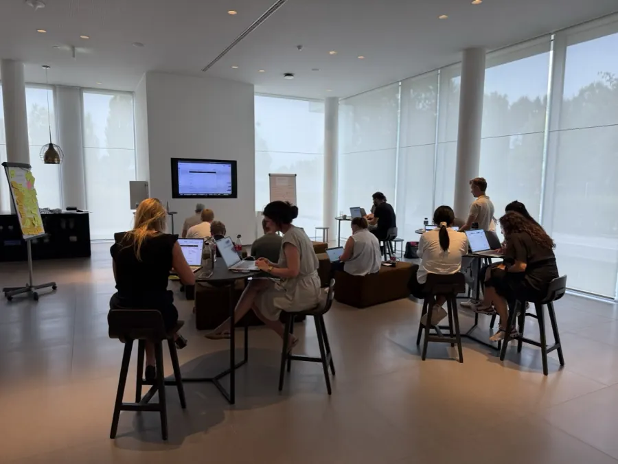 A room split into breakout groups