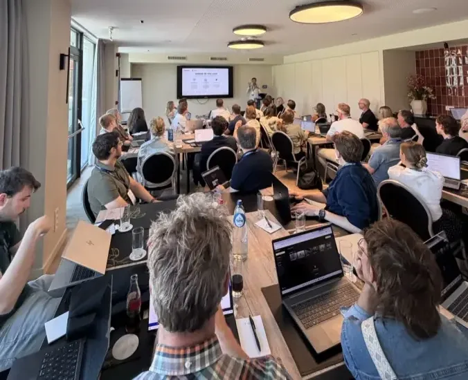 A full bootcamp room mid-session, the class following along at their laptops
